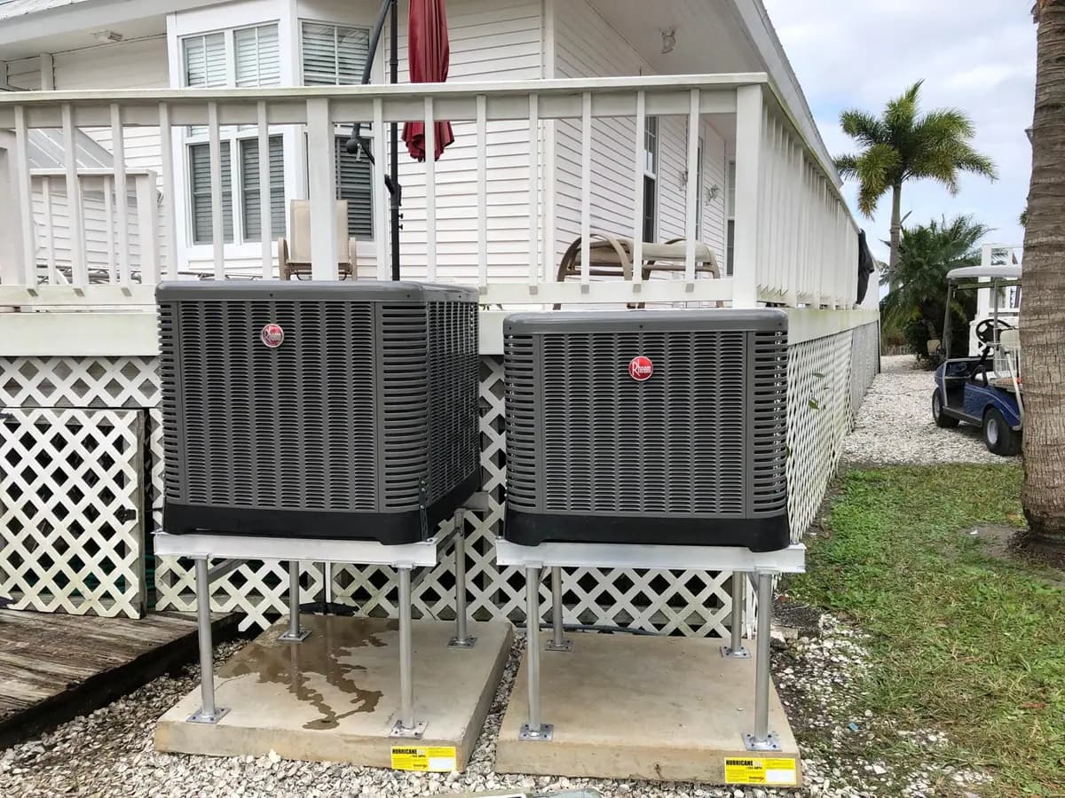 Two Rheem condensers on elevated stands at a coastal Southwest Florida home