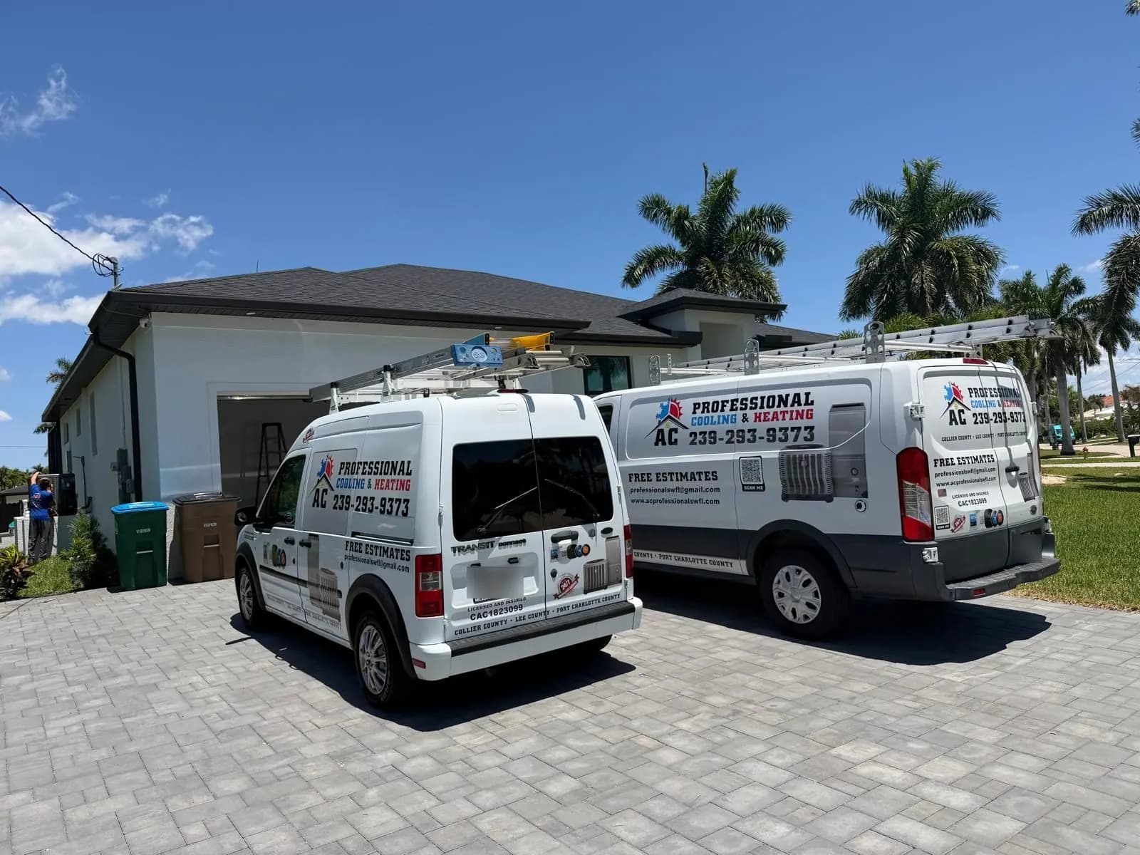 AC Professional service vans at a Southwest Florida home with a technician working on the AC system