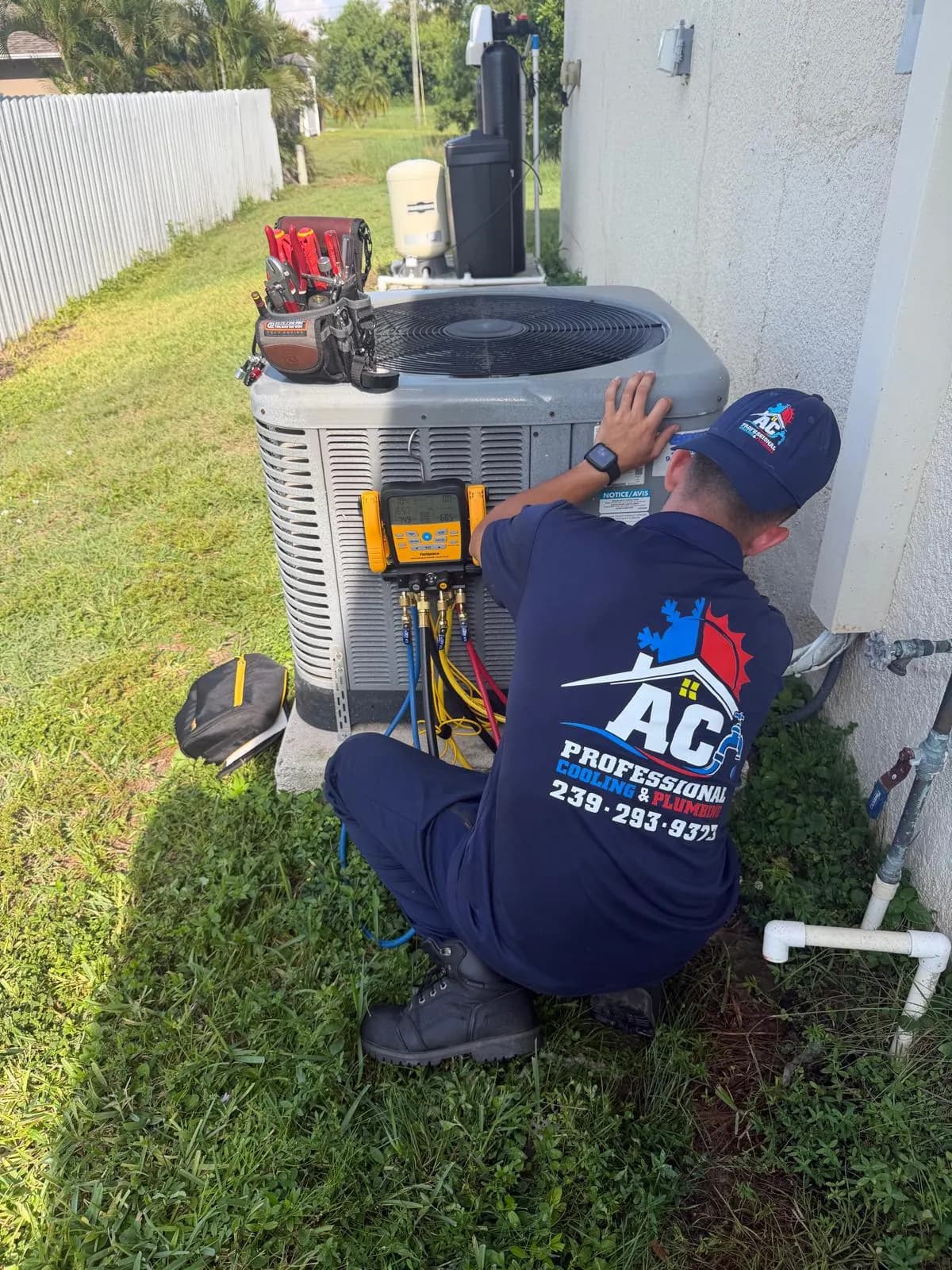 AC Professional technician checking refrigerant pressures on an outdoor AC unit