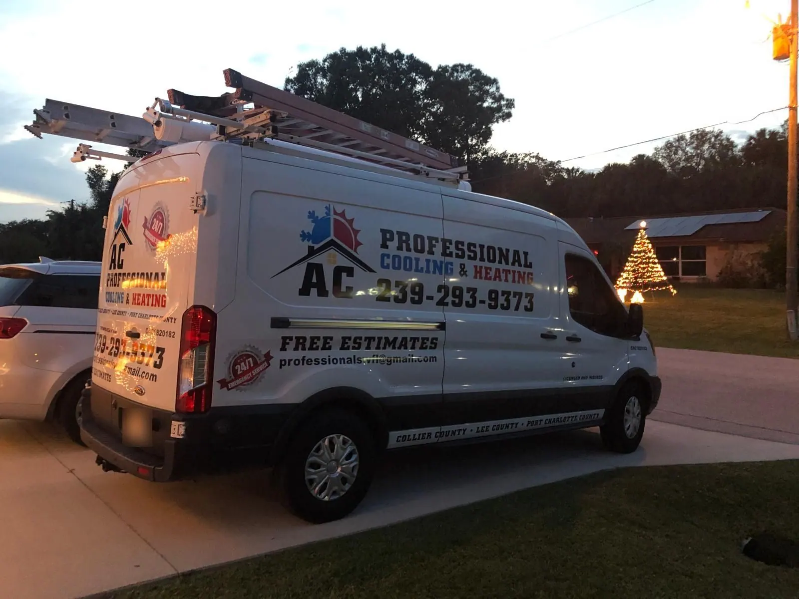 AC Professional service van arriving at a home at dusk for an evening service call