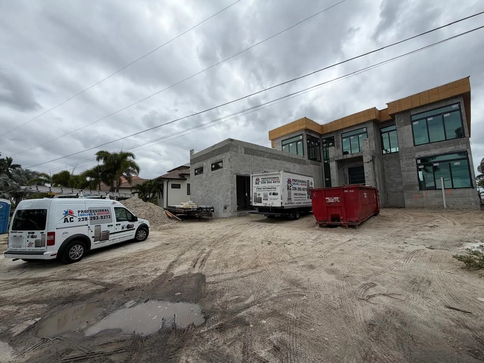 AC Professional vehicles beside a home under construction