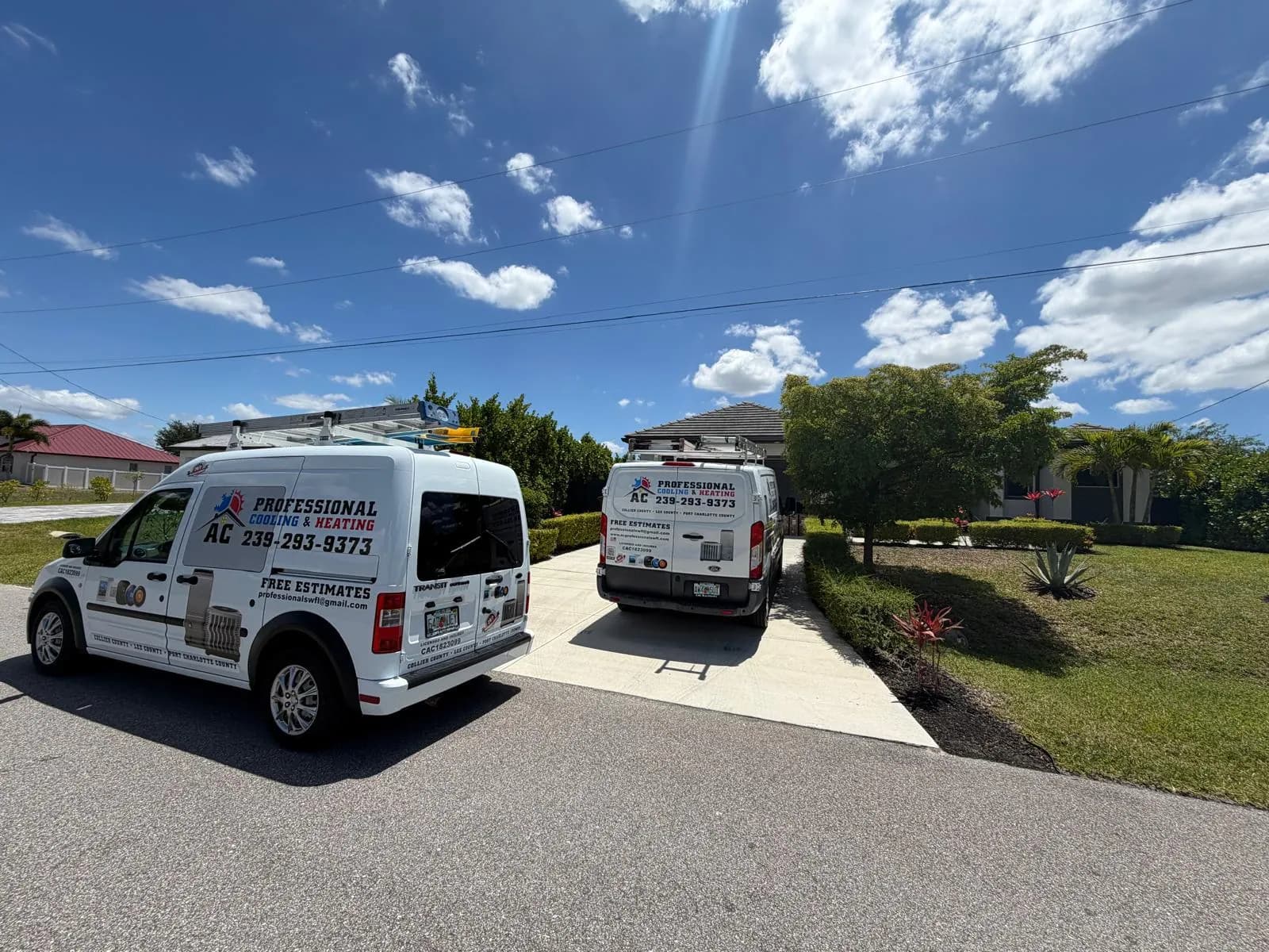 Two AC Professional service vans parked at a home