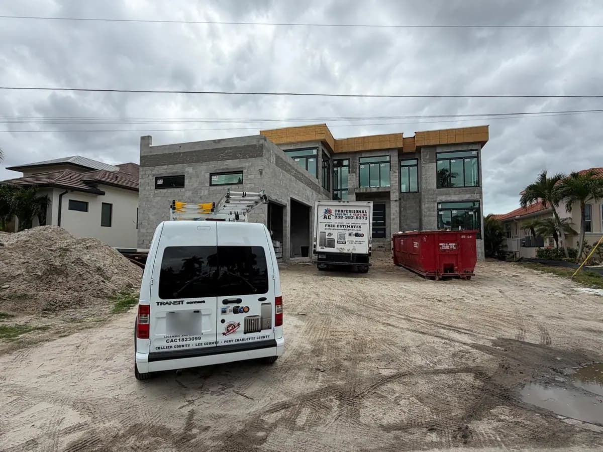 AC Professional van and truck parked at a two-story home under construction