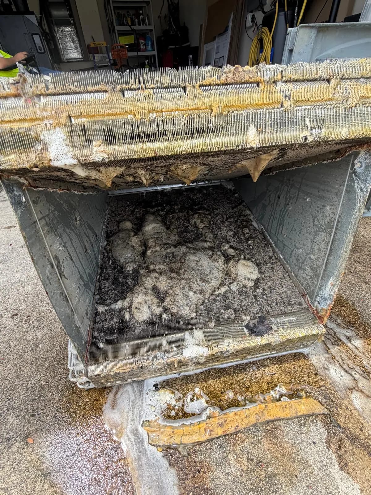 Evaporator coil and drain pan packed with debris