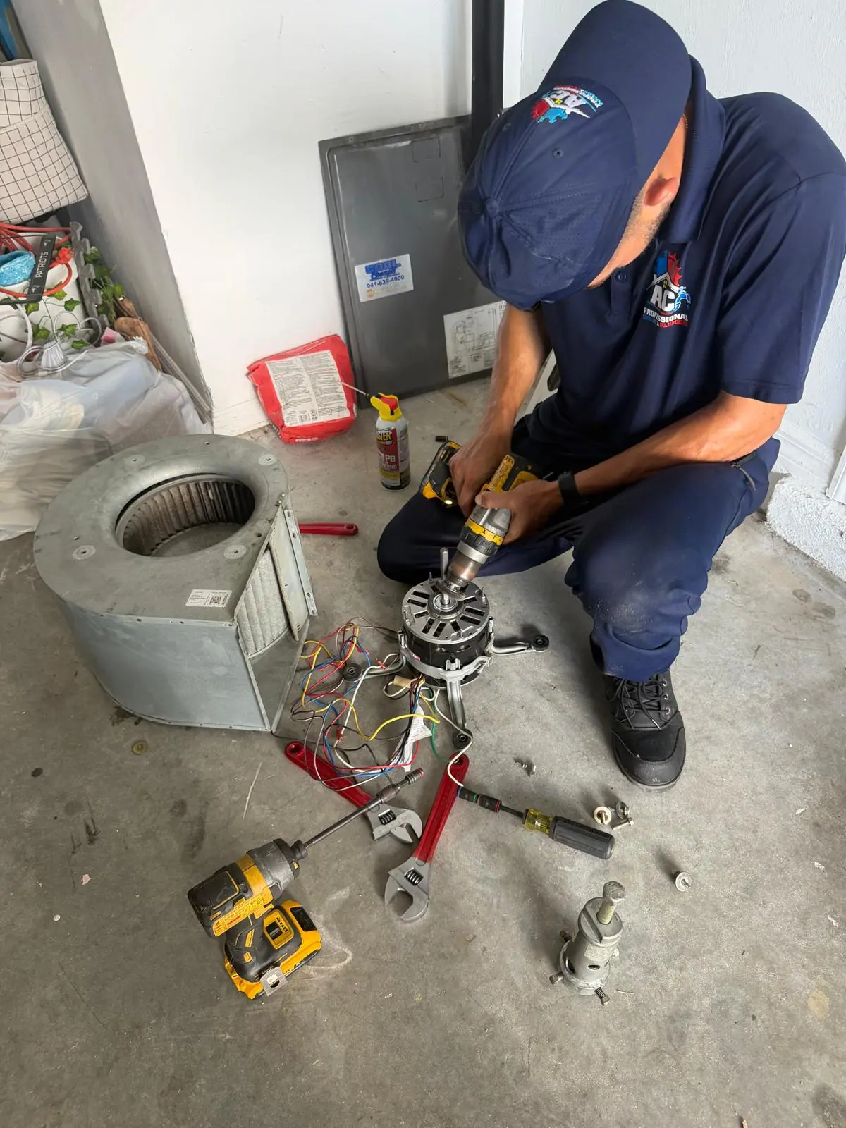 AC Professional technician servicing a blower motor during a repair visit