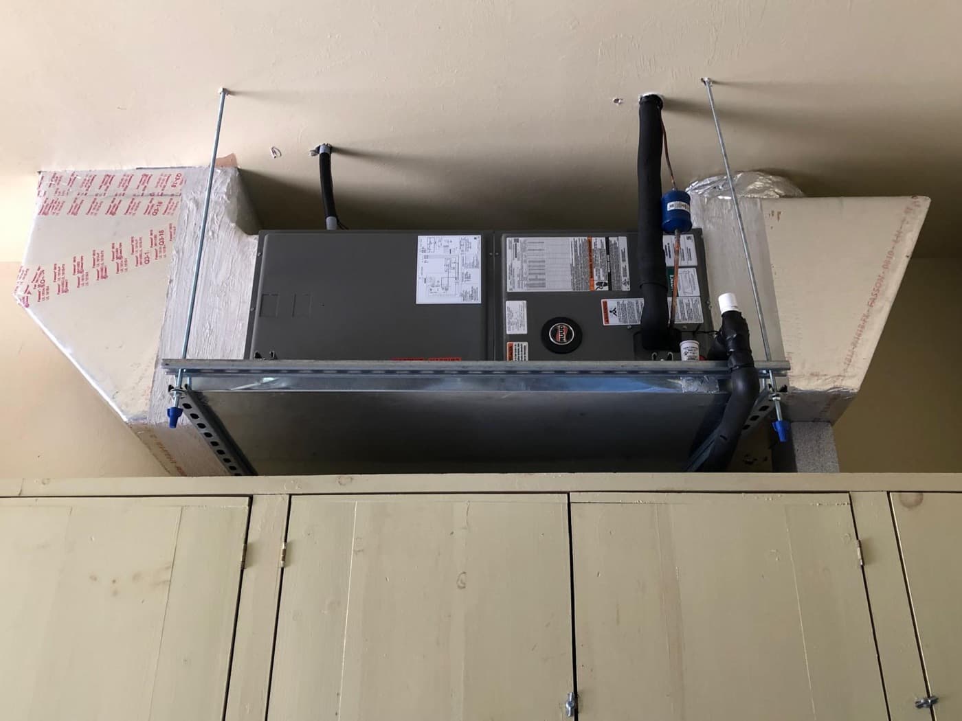 AC Professional technician servicing an air handler and heating system in Southwest Florida